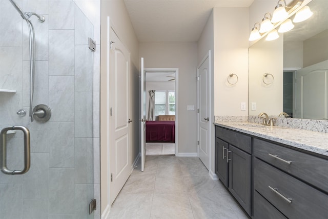 bathroom featuring vanity, tile patterned floors, and a shower with door