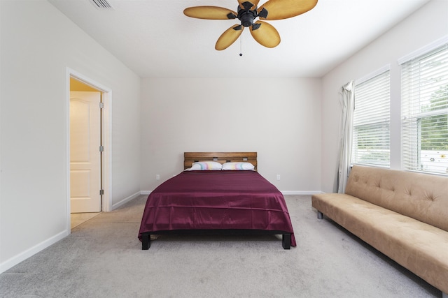 bedroom featuring ceiling fan and light carpet