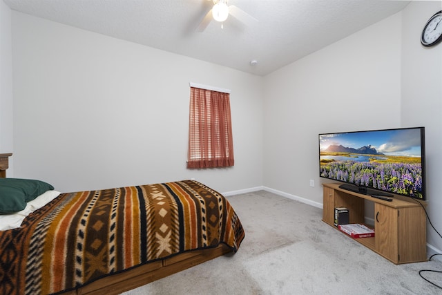 carpeted bedroom featuring a textured ceiling and ceiling fan