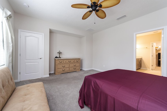 carpeted bedroom with ceiling fan, ensuite bathroom, and a textured ceiling