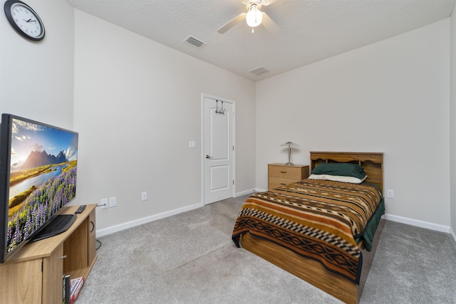 bedroom with carpet flooring, ceiling fan, and a textured ceiling