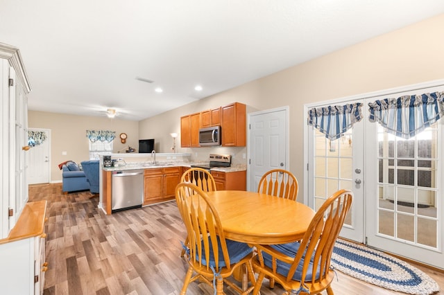 dining area featuring sink and light hardwood / wood-style flooring