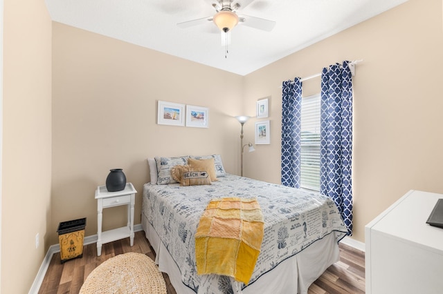 bedroom with ceiling fan and dark wood-type flooring