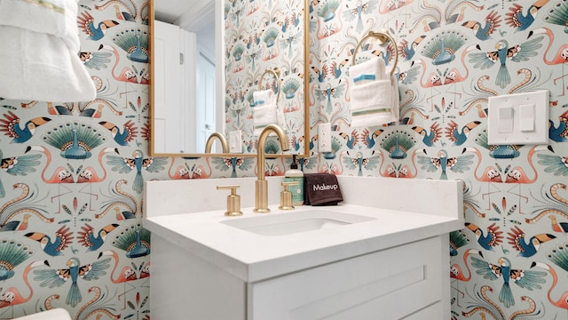 bathroom featuring vanity and wallpapered walls