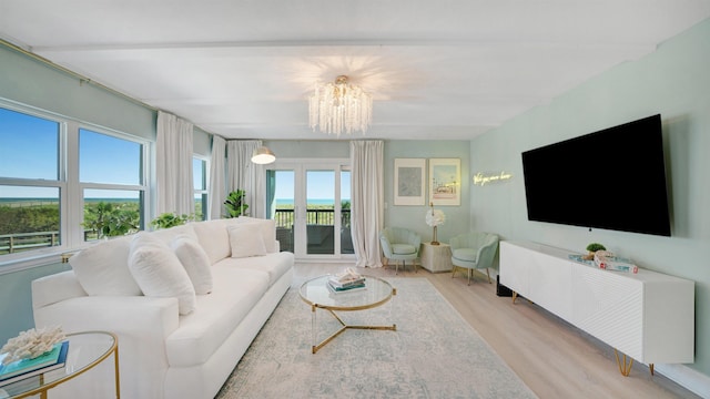 living room with a chandelier and wood finished floors