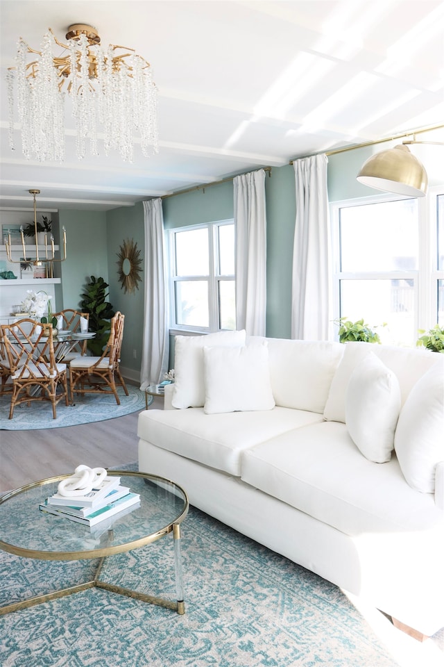 living room with a chandelier and wood finished floors