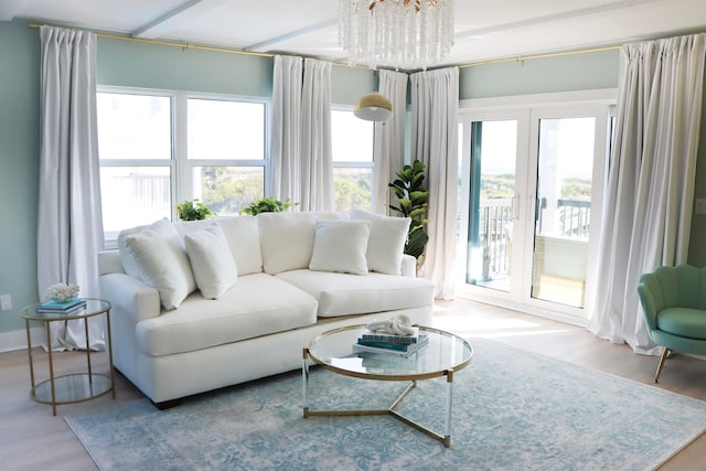 living area with a chandelier and wood finished floors