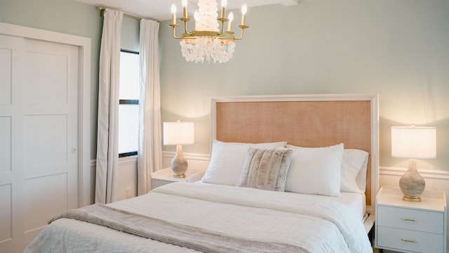 bedroom with a notable chandelier