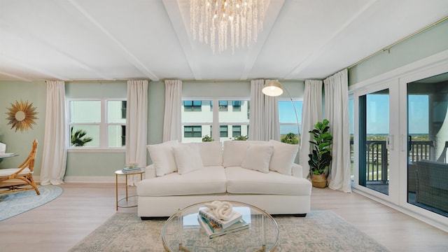 sunroom / solarium featuring a chandelier and french doors