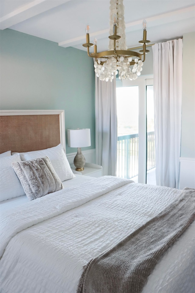 bedroom featuring a chandelier and beamed ceiling