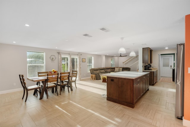 kitchen featuring stainless steel refrigerator and light parquet flooring