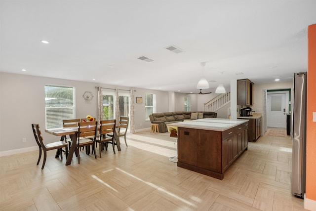 214 Deltona Blvd, Saint Augustine, FL 32086 - kitchen with open floor plan, recessed lighting, a center island, dark brown cabinetry, and freestanding refrigerator