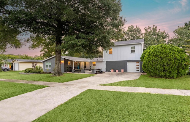 view of front of property with a lawn and a garage