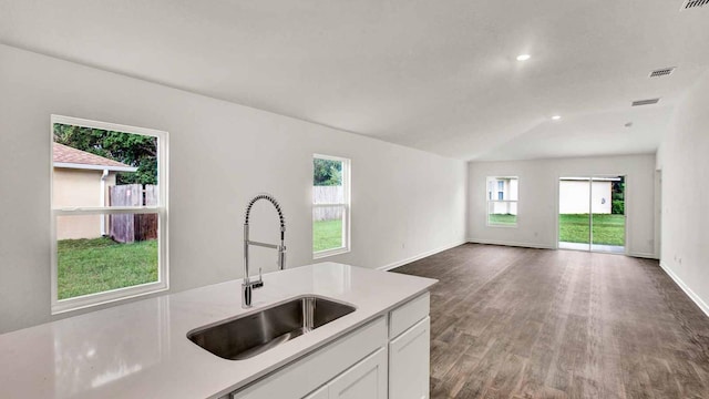 kitchen with white cabinets, lofted ceiling, sink, and dark wood-type flooring