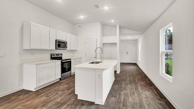 kitchen featuring sink, stainless steel appliances, lofted ceiling, a kitchen island with sink, and white cabinets