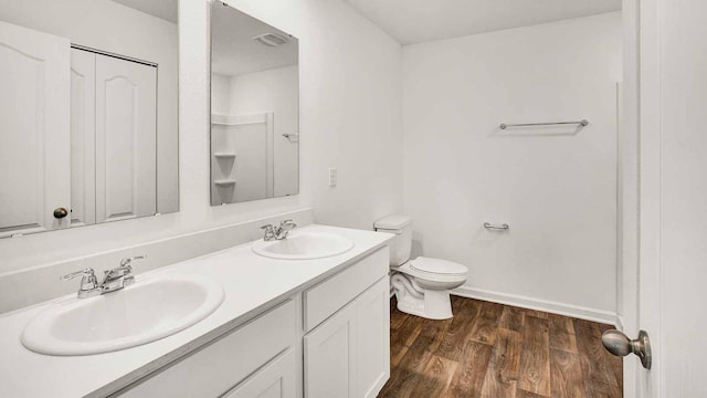 bathroom featuring vanity, toilet, and wood-type flooring