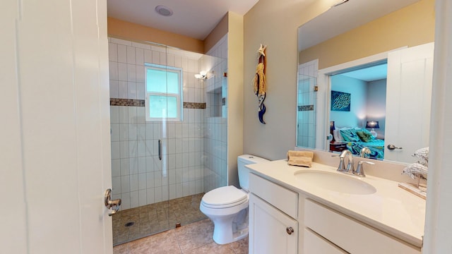 bathroom with toilet, a shower with shower door, tile patterned floors, and vanity