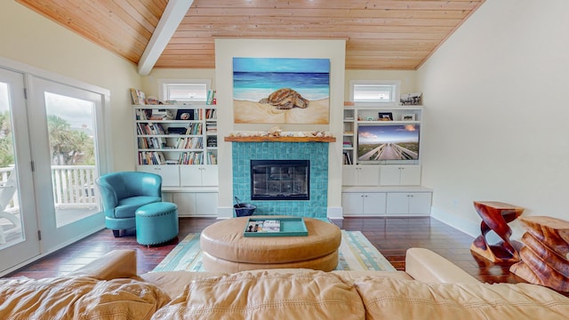 living room with dark wood-type flooring, a tile fireplace, wood ceiling, and vaulted ceiling with beams