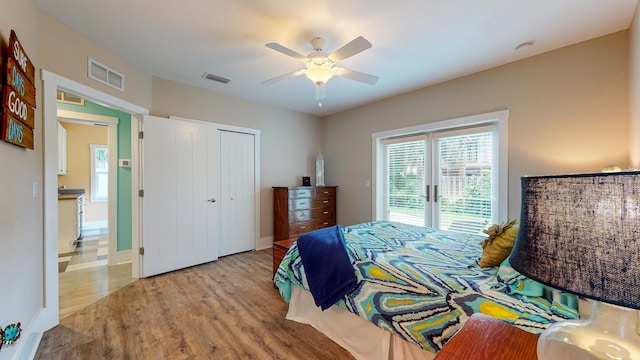 bedroom featuring ceiling fan, a closet, and light wood-type flooring