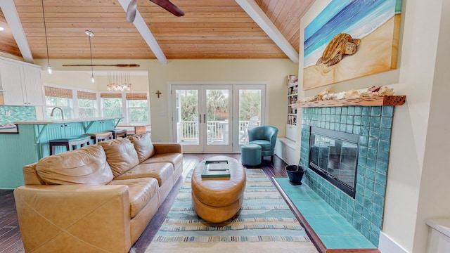 living room with wood ceiling, french doors, vaulted ceiling with beams, dark wood-type flooring, and a tiled fireplace