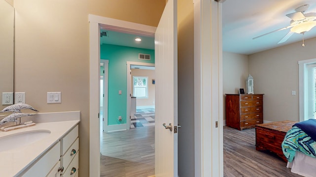 bathroom featuring vanity, ceiling fan, and wood-type flooring