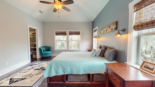 bedroom featuring ceiling fan, a spacious closet, and vaulted ceiling