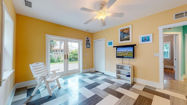 interior space with ceiling fan and french doors