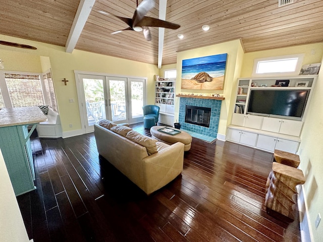 living room featuring a fireplace, beamed ceiling, ceiling fan, and wood ceiling