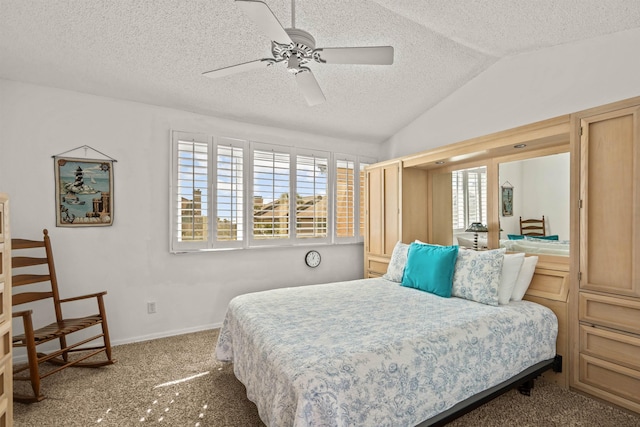 bedroom featuring vaulted ceiling, carpet floors, a textured ceiling, and ceiling fan