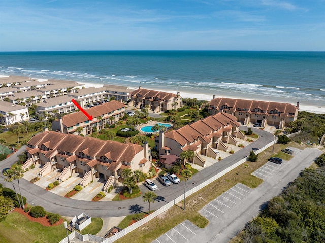 birds eye view of property featuring a water view and a beach view