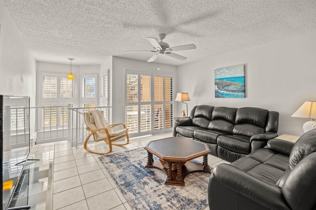 tiled living room featuring ceiling fan and a textured ceiling