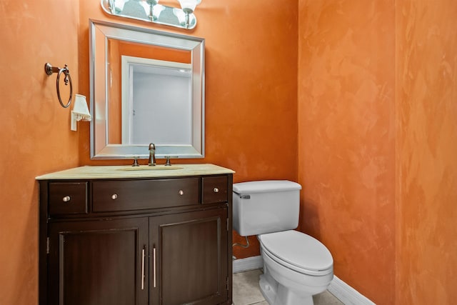 bathroom with vanity, toilet, and tile patterned flooring