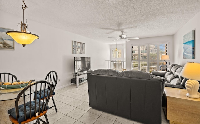 tiled living room featuring ceiling fan and a textured ceiling