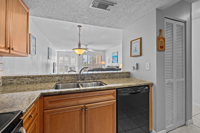 kitchen with light tile patterned flooring, sink, a textured ceiling, and black appliances