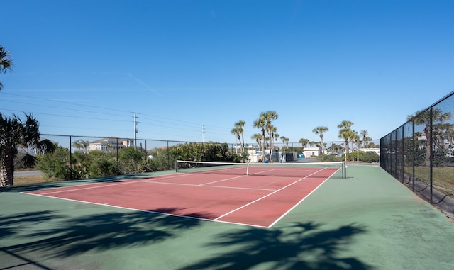 view of tennis court with basketball hoop