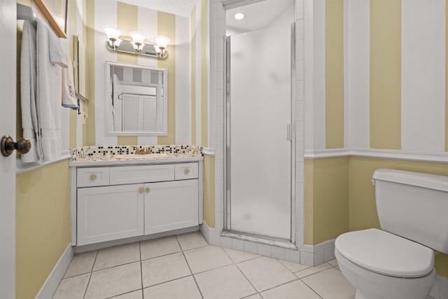 bathroom featuring tile patterned flooring, vanity, toilet, a shower with door, and a textured ceiling