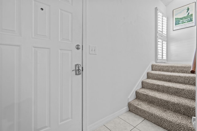 stairs with tile patterned floors