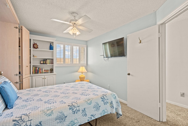 carpeted bedroom with a textured ceiling and ceiling fan