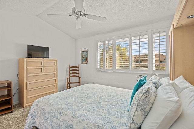 carpeted bedroom with lofted ceiling, a textured ceiling, and ceiling fan