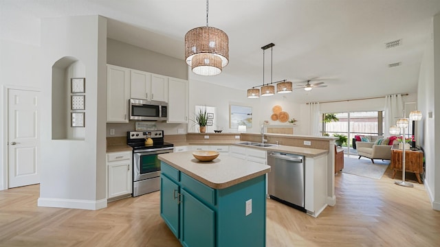 2020 Spring Meadows Ct, Saint Augustine, FL 32092 - kitchen with appliances with stainless steel finishes, a sink, a peninsula, ceiling fan, and white cabinetry