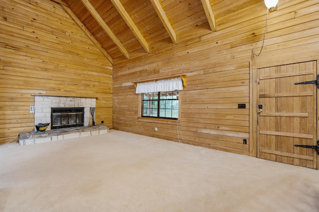 5850 Capo Island Rd, Saint Augustine, FL 32095 - unfurnished living room with carpet, wooden walls, a wood ceiling with exposed beams, a fireplace, and high vaulted ceiling