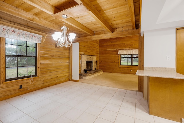 5850 Capo Island Rd, Saint Augustine, FL 32095 - unfurnished living room with wood walls, a wood ceiling with exposed beams, a chandelier, a stone fireplace, and light colored carpet