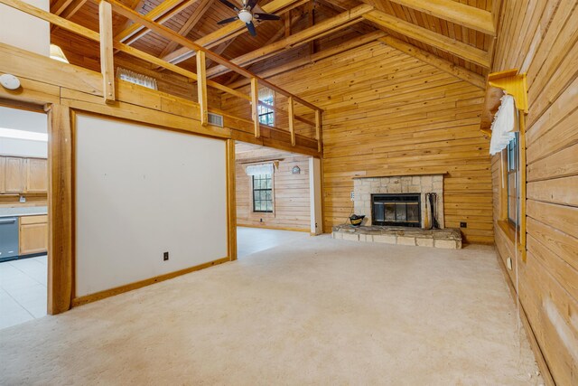 5850 Capo Island Rd, Saint Augustine, FL 32095 - unfurnished living room featuring wooden ceiling, wood walls, a ceiling fan, a stone fireplace, and high vaulted ceiling