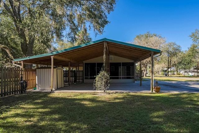 view of community featuring a lawn and a storage unit