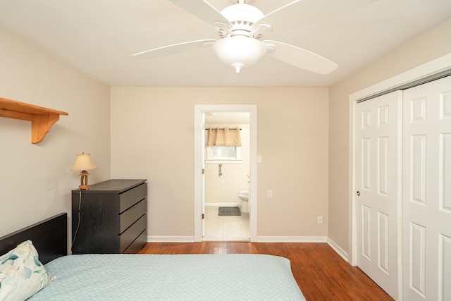 bedroom with hardwood / wood-style floors, connected bathroom, a closet, and ceiling fan