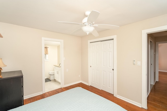 bedroom featuring connected bathroom, ceiling fan, a closet, and light hardwood / wood-style floors