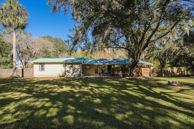 rear view of property with a yard