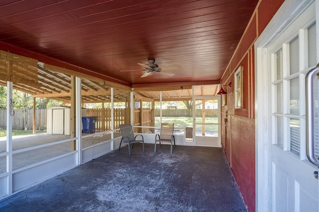 unfurnished sunroom featuring ceiling fan and wooden ceiling