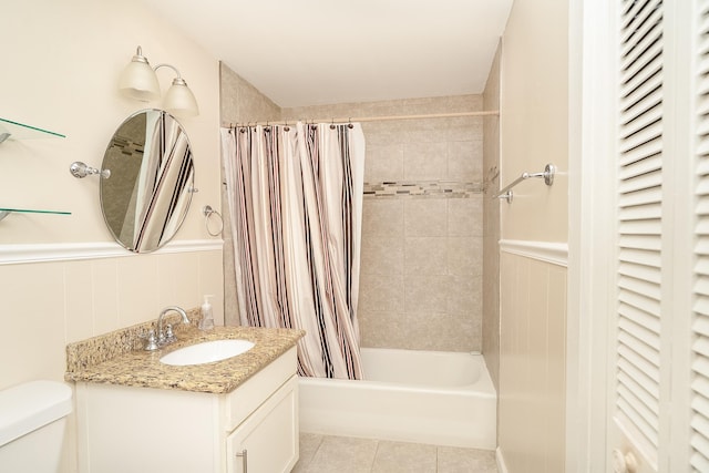 full bathroom featuring tile patterned flooring, shower / bath combo, vanity, and toilet