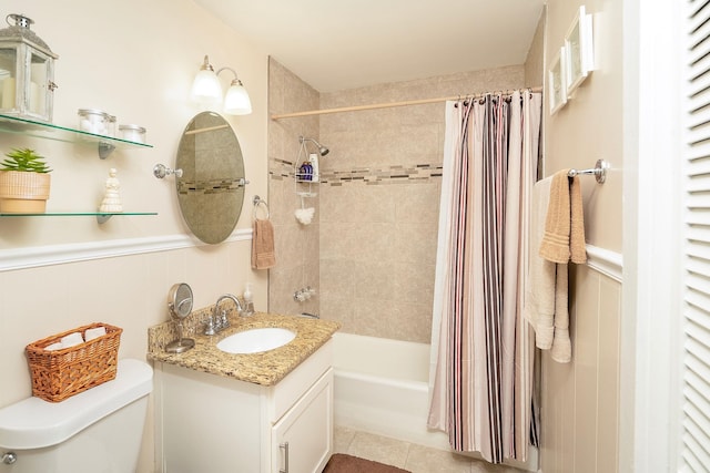 full bathroom featuring tile patterned floors, vanity, toilet, and shower / bathtub combination with curtain